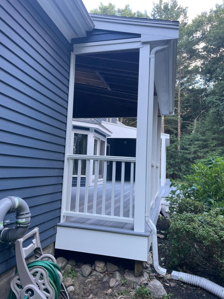 Covered porch in Westwood, Massachusetts by Monroy's Carpenters, Inc