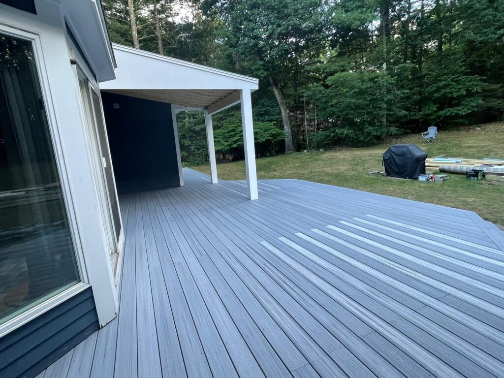 Deck building with composite planks in Westwood, MA by Monroy's Carpenters, Inc