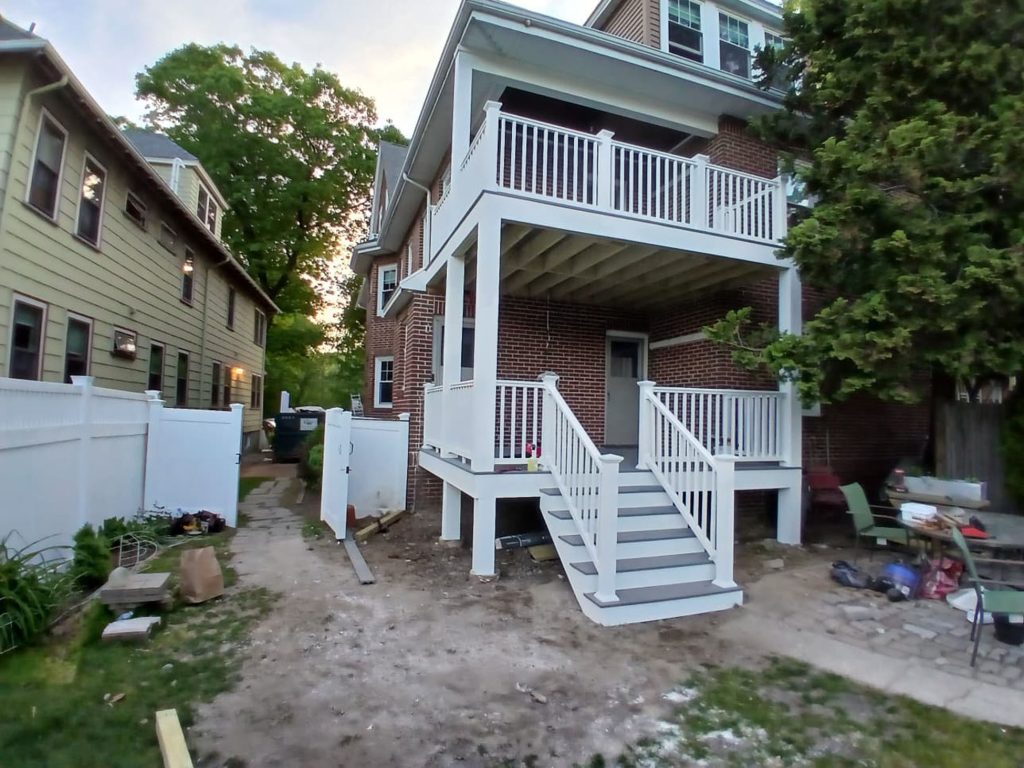 Multi-level deck replacement in Boston, MA by Monroy’s Carpenters, Inc. showing framing and finished deck construction.